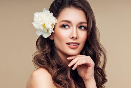 Beautiful portrait of young girl with flower in her hair